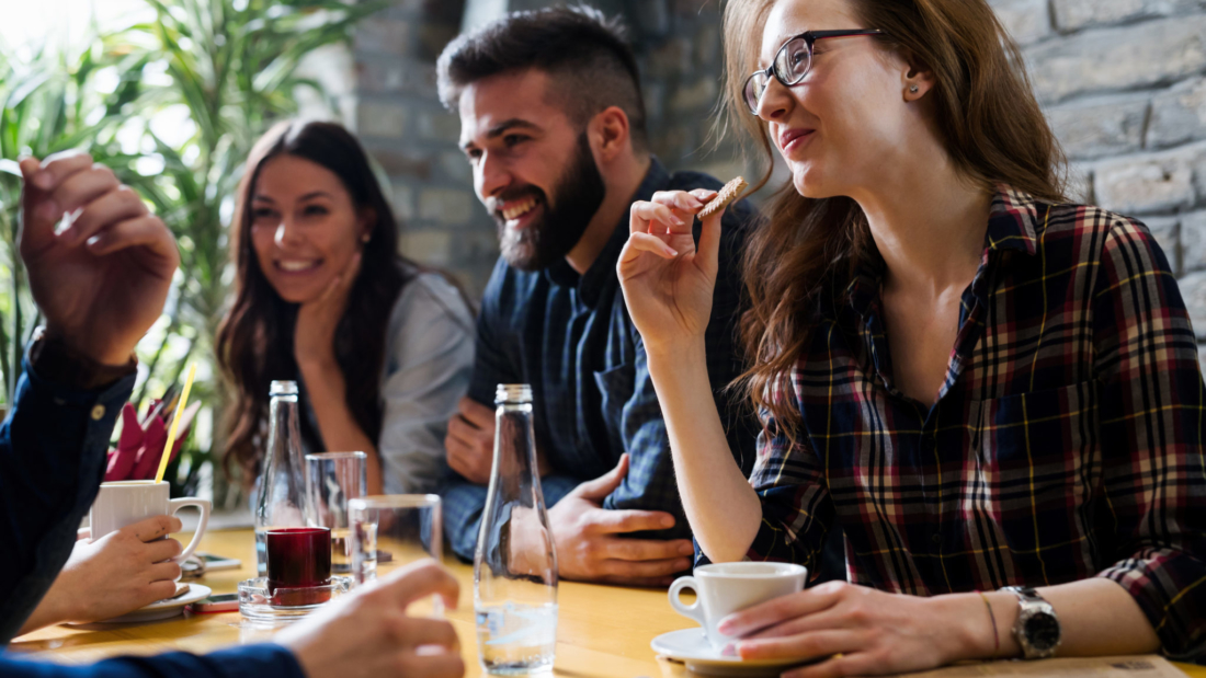 Happy young friends hangout together in coffee shop