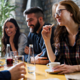 Happy young friends hangout together in coffee shop